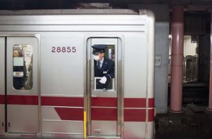 Japanese train worker using a face mask during the COVID pandemic