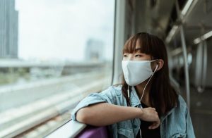 Woman using a face mask in South Korea while the country deploys a COVID pass.