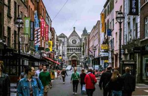 Irish citizens walking down the street after getting a green social pass to travel